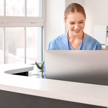 Vein Care Friendly medical staff at reception desk, representing a welcoming vein care experience at The Vein Guys
